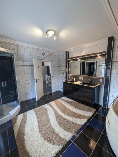 a kitchen with a rug in the middle of a room at Hotel Eiserner Anton in Bielefeld