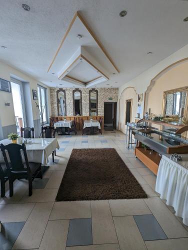 a restaurant with tables and chairs and a large room at Hotel Eiserner Anton in Bielefeld