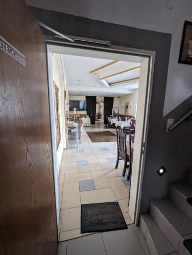 a hallway with a door leading to a dining room at Hotel Eiserner Anton in Bielefeld