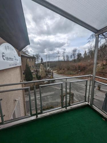 a view of a golf course from a balcony at Hotel Eiserner Anton in Bielefeld