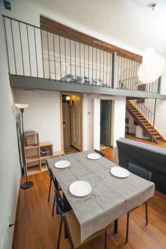 a dining room with a table and a couch at Solmi Home in Modena
