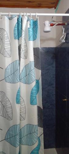 a shower curtain in a bathroom next to a sink at Depto muy confortable in Corrientes