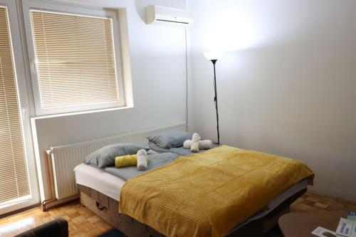 a bedroom with a bed with two stuffed animals on it at Apartman Bošković in Donji Milanovac