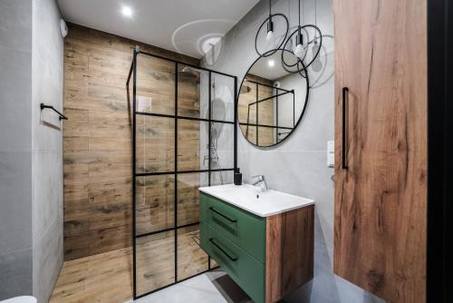 a bathroom with a green sink and a mirror at Młyn Wrocław 10/8 in Wrocław