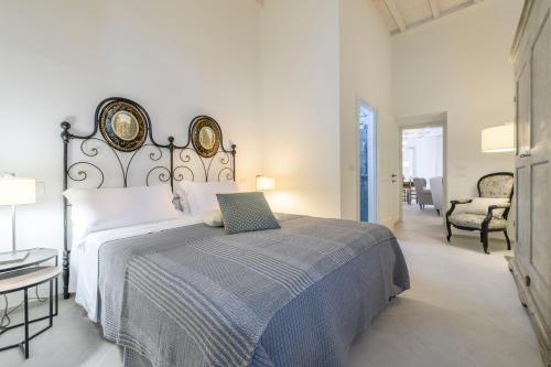 a bedroom with a bed with a laptop on it at Albergo Diffuso Borgo Santo in Asciano