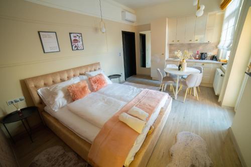 a bedroom with a bed and a table in a kitchen at Dream Apartments in Szeged