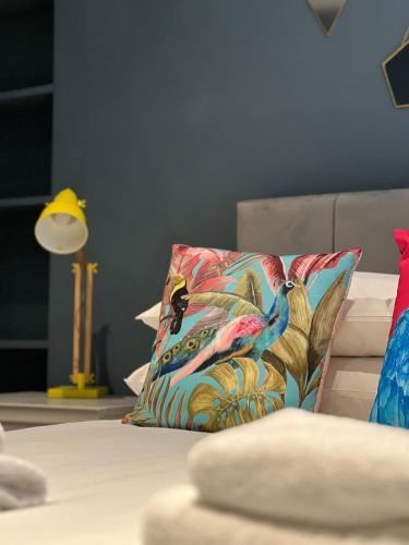 a pillow sitting on a bed next to a lamp at Stable Yard Rooms in Richmond