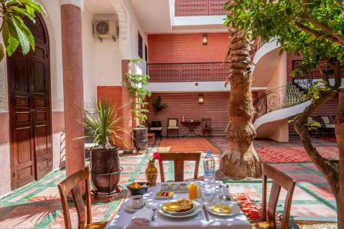 a table with food on it in a courtyard at riad dar nejma & Spa in Marrakech