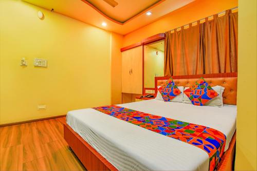 a bedroom with a large bed in a room at FabHotel AG Star in kolkata