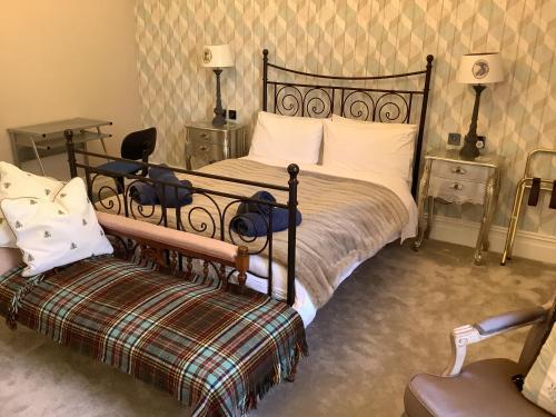 a bedroom with a bed and a couch and a chair at Brookfield House Warcop in Warcop