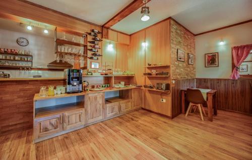 a kitchen with wooden cabinets and a counter top at Plitvice Lower Lakes Rooms in Plitvička Jezera