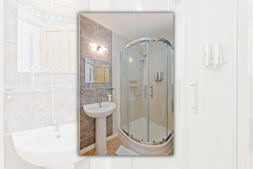 a bathroom with a shower and a sink at White Rose Guest House in Filey