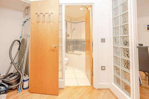 a bathroom with a glass door leading to a shower at Luxury Modern 1 Bedroom Apartment In Birmingham City Centre-Free Parking in Birmingham