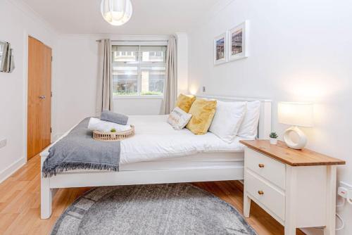 a white bed in a room with a window at Luxury Modern 1 Bedroom Apartment In Birmingham City Centre-Free Parking in Birmingham