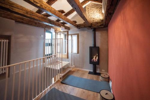 a room with a staircase with a fire in the fireplace at Casa del Carro 2 Grand Terrace Apartment in Venice