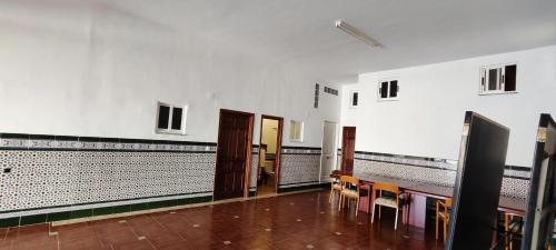 a room with tables and chairs in a building at Villa Granada Motril in Motril