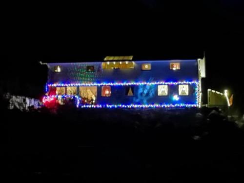 a house with christmas lights on the side of it at Iris Vedal in Nauste