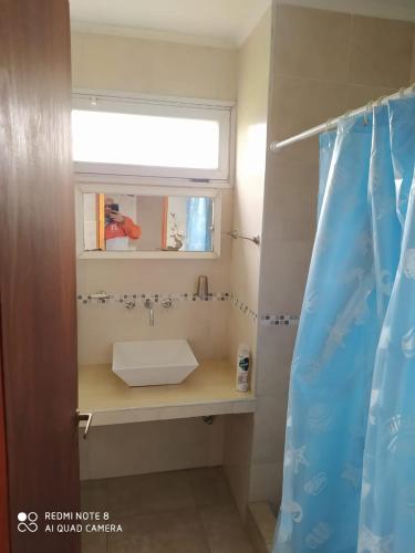 a bathroom with a sink and a window at HUAYCAMAR in Playa Dorada