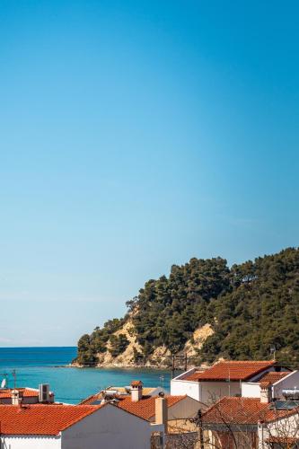 a view of a town and the ocean with houses at Samel Hotel in Siviri