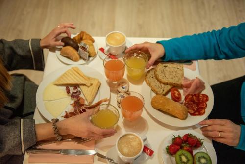 a group of people sitting around a table with food at El Petit Convent in Begur
