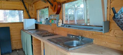 a kitchen with a sink in a wooden cabin at Pod Berdem in Wetlina