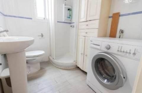 a bathroom with a washing machine and a sink at 38 - Habitacion en piso in Alicante