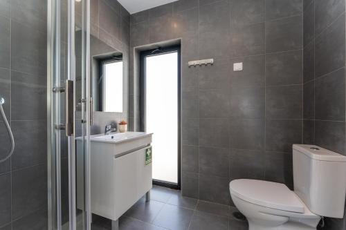 a bathroom with a toilet and a sink at Villa Hobie Cat in Sagres
