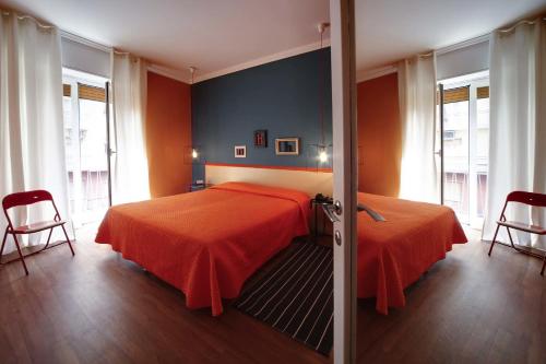 a bedroom with two beds and two chairs at Residence Pian della Nave in Milan