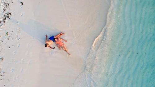 an aerial view of a man on a beach at Ari Grand Hotel & Spa in Dhangethi