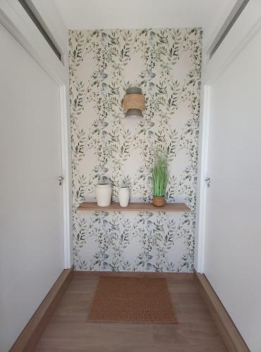 a hallway with two potted plants on a wall at Alojamientos rurales Arbonaida in Baños de la Encina