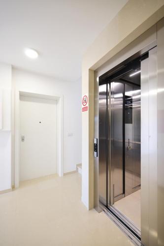 an elevator in an office building with a glass door at Leonardo Luxury Residence 2 Penthouse with jacuzzi in Zadar