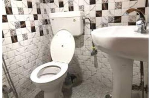 een badkamer met een toilet en een wastafel bij Amar Resort in Rudraprayāg