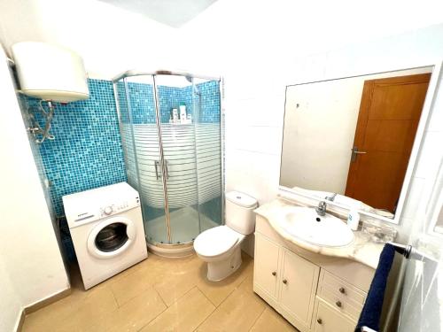 a bathroom with a toilet sink and a washing machine at ALCAMAR APARTMENT! with beautiful views of the sea! in Alcalá