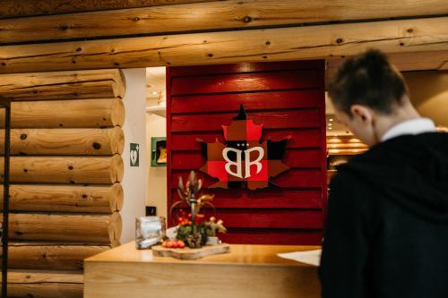 a man standing at a counter in a restaurant at Badhotel Rockanje in Rockanje