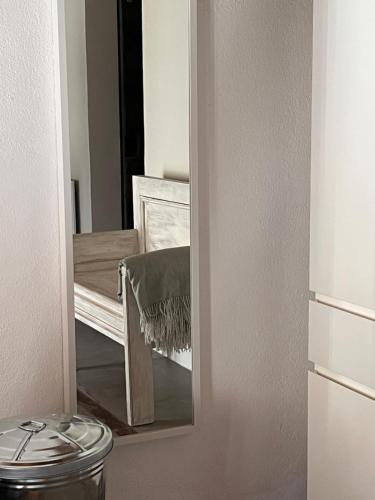 a mirror in a bathroom next to a toilet at Gästehaus Sille in Morsbach - Holpe in Morsbach