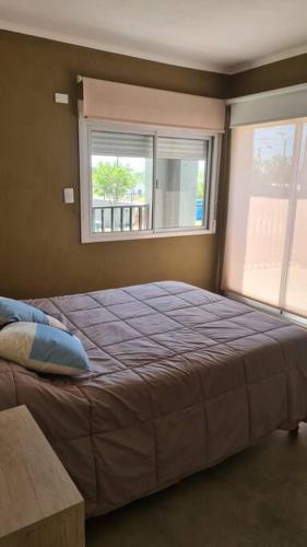 a bedroom with a large bed and a window at Villa Albertina HOUSE-Villa María in Villa María