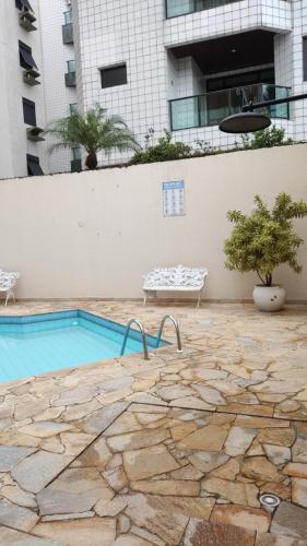 een zwembad voor een gebouw bij Enseada Guarujá Ap214 in Guarujá