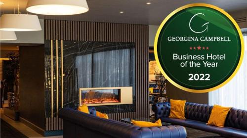 a business hotel of the year sign in a room with a couch at Nox Hotel Galway in Galway
