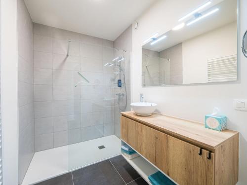 a bathroom with a sink and a shower at Bright apartment on the first floor in Middelkerke