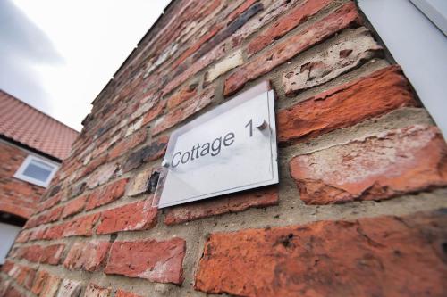 a sign on the side of a brick building at Murton Grange in York