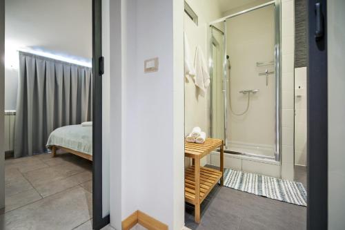 a bathroom with a shower and a bedroom at Residence Antonio - Deluxe Apartments & Rooms in Rovinj