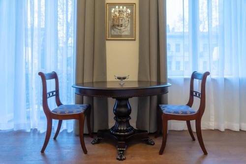 a table and two chairs sitting next to a window at TIFLIS OPERA Aparthotel in Tbilisi City