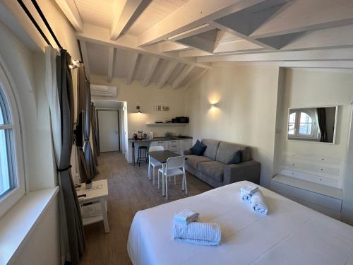 a bedroom with a bed and a living room at Garden Lodge in Stresa