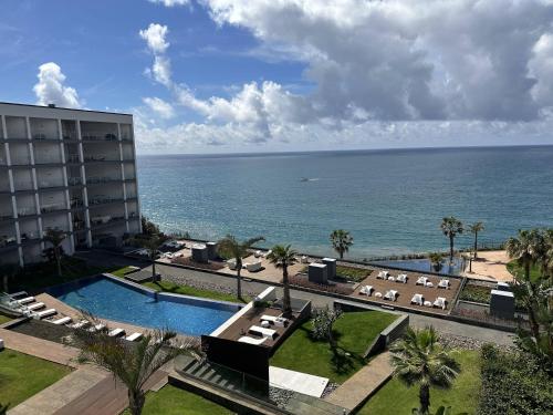 a view of the ocean from a hotel with a swimming pool at Madeira Palace Residences in Funchal