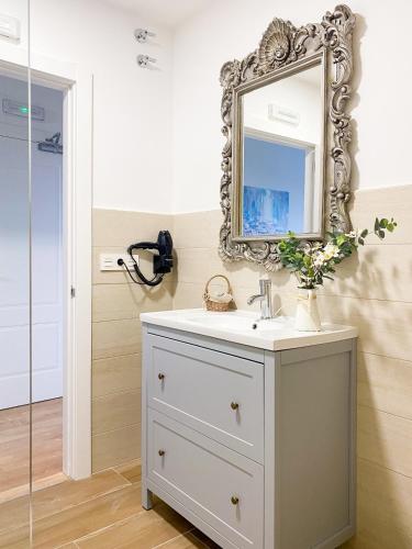 a bathroom with a sink and a mirror on the wall at Villaprado in Cambados