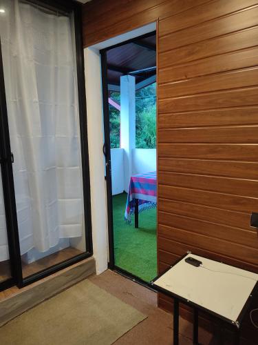 a door leading into a room with a window at Foggy Mount View in Bandarawela