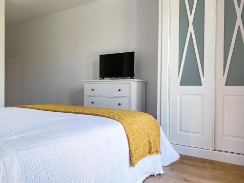 a bedroom with a bed and a television on a dresser at Villaprado in Cambados