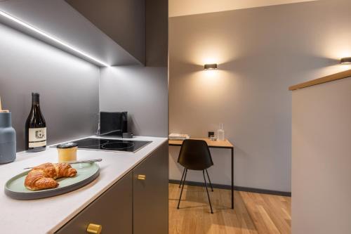 a kitchen with a plate of croissants on a counter at ipartment Berlin Airport in Schönefeld