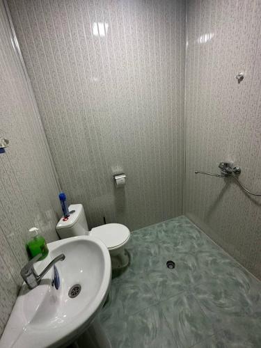 a bathroom with a sink and a toilet at Guest house Lovely Guest in Bukhara