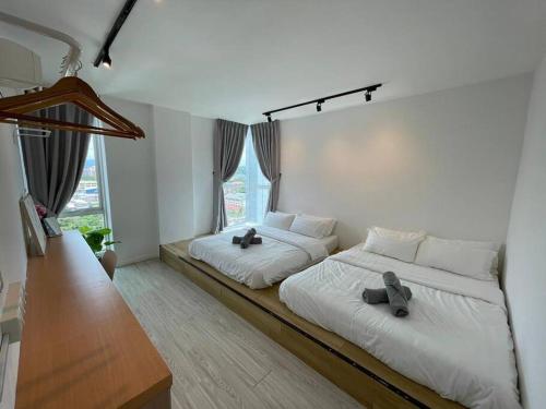 a bedroom with two beds with shoes on them at 3bedroom Sutera Avenue Kota Kinabalu by Twen8ty Homestay in Kota Kinabalu